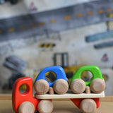 A red coloured Bajo Auto Transporter. The wooden toy car transporter comes with two toy cars. These heirloom quality toys by Bajo are part of a wide range of wooden toys available here at Babipur. 