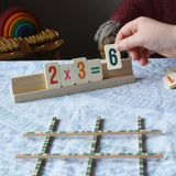 Bajo toys wooden easy maths learning set. Child placing wooden number tiles on the wooden stand.
