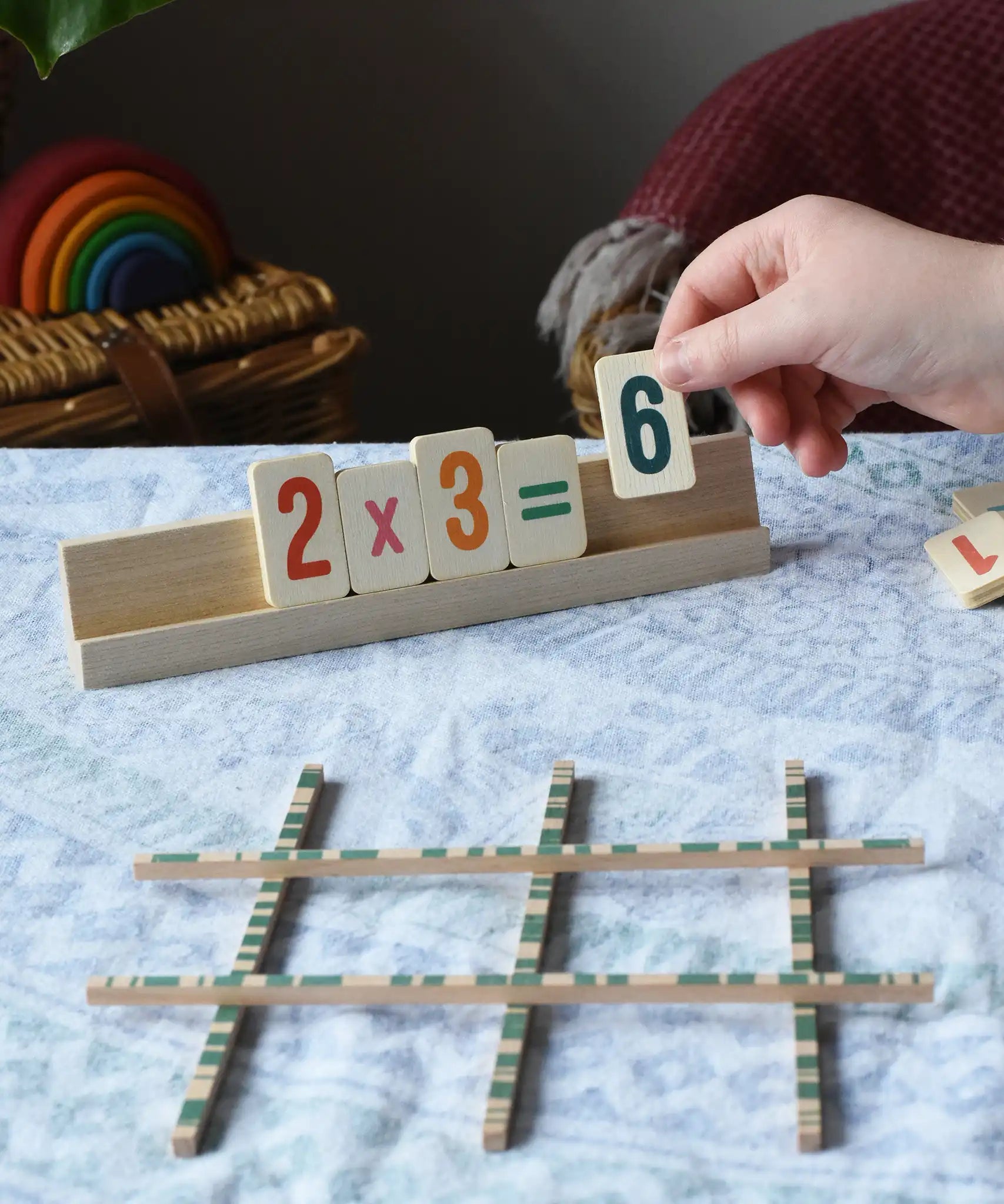 Bajo toys wooden easy maths learning set. Child placing wooden number tiles on the wooden stand.