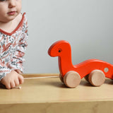 A child pulling a red coloured Bajo wriggling worm along the Miri slide. These heirloom quality toys by Bajo are part of a wide range of wooden toys available here at Babipur.  