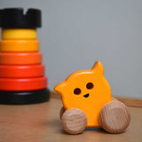 A Bajo push along eye ghost wooden toy placed on Triclimb Miri slide with a Bajo rook tower stacking toy in the background. These heirloom quality toys by Bajo are part of a wide range of wooden toys available here at Babipur. 