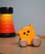 A Bajo push along eye ghost wooden toy placed on Triclimb Miri slide with a Bajo rook tower stacking toy in the background. These heirloom quality toys by Bajo are part of a wide range of wooden toys available here at Babipur. 