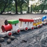 Bajo wooden train to build fully assembled and standing on a log in the park