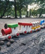 Bajo wooden train to build fully assembled and standing on a log in the park