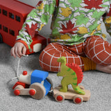 A child playing with the Bajo choo-choo train wooden pull-along toy. These heirloom quality toys by Bajo are part of a wide range of wooden toys available here at Babipur.