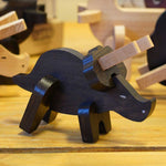 A built Bajo Puzzle & Sorter - Black Oak Triceratops stood on a wooden table