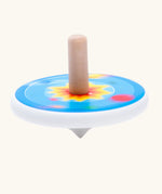 Bajo universe wooden spinning top toy blurred in motion as it spins around.