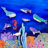 The wooden whale figures from the Bajo whale family puzzle shown placed on a Wonderie sea themed play cloth. These heirloom quality toys by Bajo are part of a wide range of wooden toys available here at Babipur. 