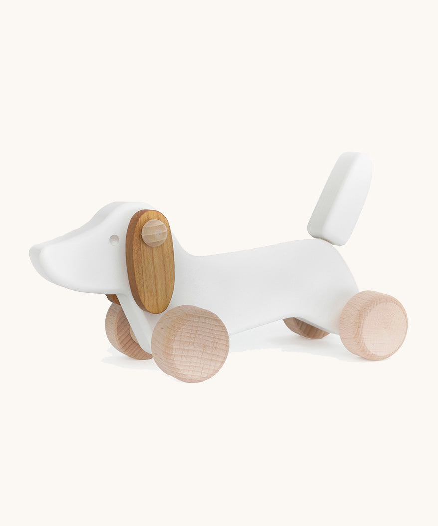 Bajo wooden white dachshund puppy available at Babipur. Features unpainted wheels to push and pull