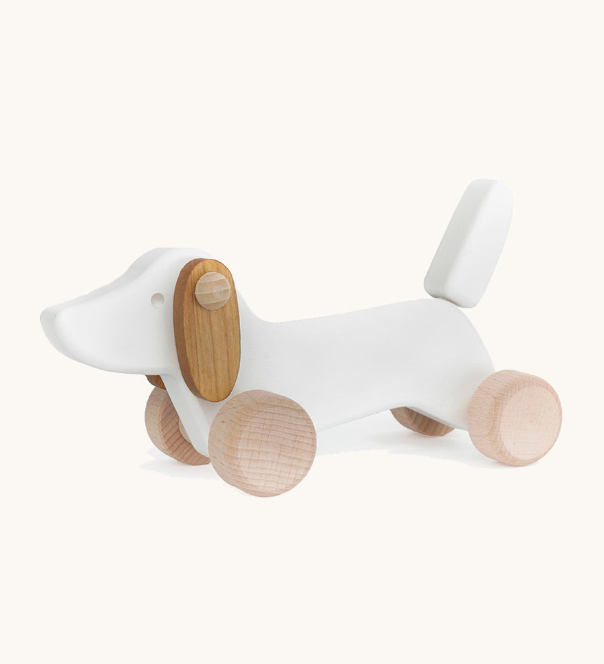 Bajo wooden white dachshund puppy available at Babipur. Features unpainted wheels to push and pull