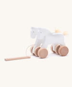 Bajo hand made wooden jumping horse in white and.available at Babipur. Features unpainted wheels  and a toggle to pull along the horses