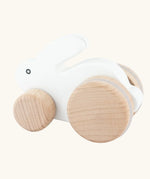 Bajo small white rabbit wooden push along toy. White painted bunny rabbit on natural wooden wheels.