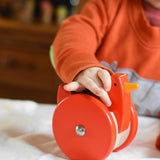 A child playing with the A child playing with the Bajo Red Wobbling Chicken. A red push along wooden chicken toy that bob up and down when pushed along.  These heirloom quality toys by Bajo are part of a wide range of wooden toys available here at Babipur.