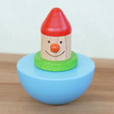 Bajo roly poly wobbling dwarf wooden baby toy. Blue half sphere base that wobbles when pushed with a wooden dwarf character on top from Babipur