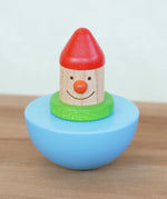 Bajo roly poly wobbling dwarf wooden baby toy. Blue half sphere base that wobbles when pushed with a wooden dwarf character on top from Babipur