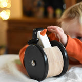 A child playing with the Bajo wobbling penguin push along wooden toy. This toy penguin has large black wheels. These heirloom quality toys by Bajo are part of a wide range of wooden toys available here at Babipur. 