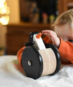 A child playing with the Bajo wobbling penguin push along wooden toy. This toy penguin has large black wheels. These heirloom quality toys by Bajo are part of a wide range of wooden toys available here at Babipur. 