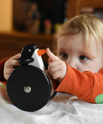A child playing with the Bajo wobbling penguin push along wooden toy. This toy penguin has large black wheels. These heirloom quality toys by Bajo are part of a wide range of wooden toys available here at Babipur. 