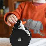 A child playing with the Bajo wobbling penguin push along wooden toy. This toy penguin has large black wheels. These heirloom quality toys by Bajo are part of a wide range of wooden toys available here at Babipur. 