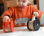 A child playing with the A child playing with the Bajo Red Wobbling Chicken and wobbling penguin toys. A red push along wooden chicken toy that bob up and down when pushed along.  These heirloom quality toys by Bajo are part of a wide range of wooden toys available here at Babipur.