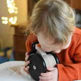 A child cuddling the Bajo wobbling penguin push along wooden toy. This toy penguin has large black wheels. These heirloom quality toys by Bajo are part of a wide range of wooden toys available here at Babipur. 