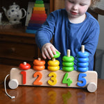 A child playing with a Bajo 1-5 pull along stacking toy