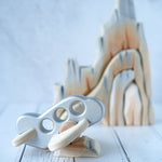 A silver coloured Bajo airplane pictured resting on a piece of the Bumbu Cliffs
