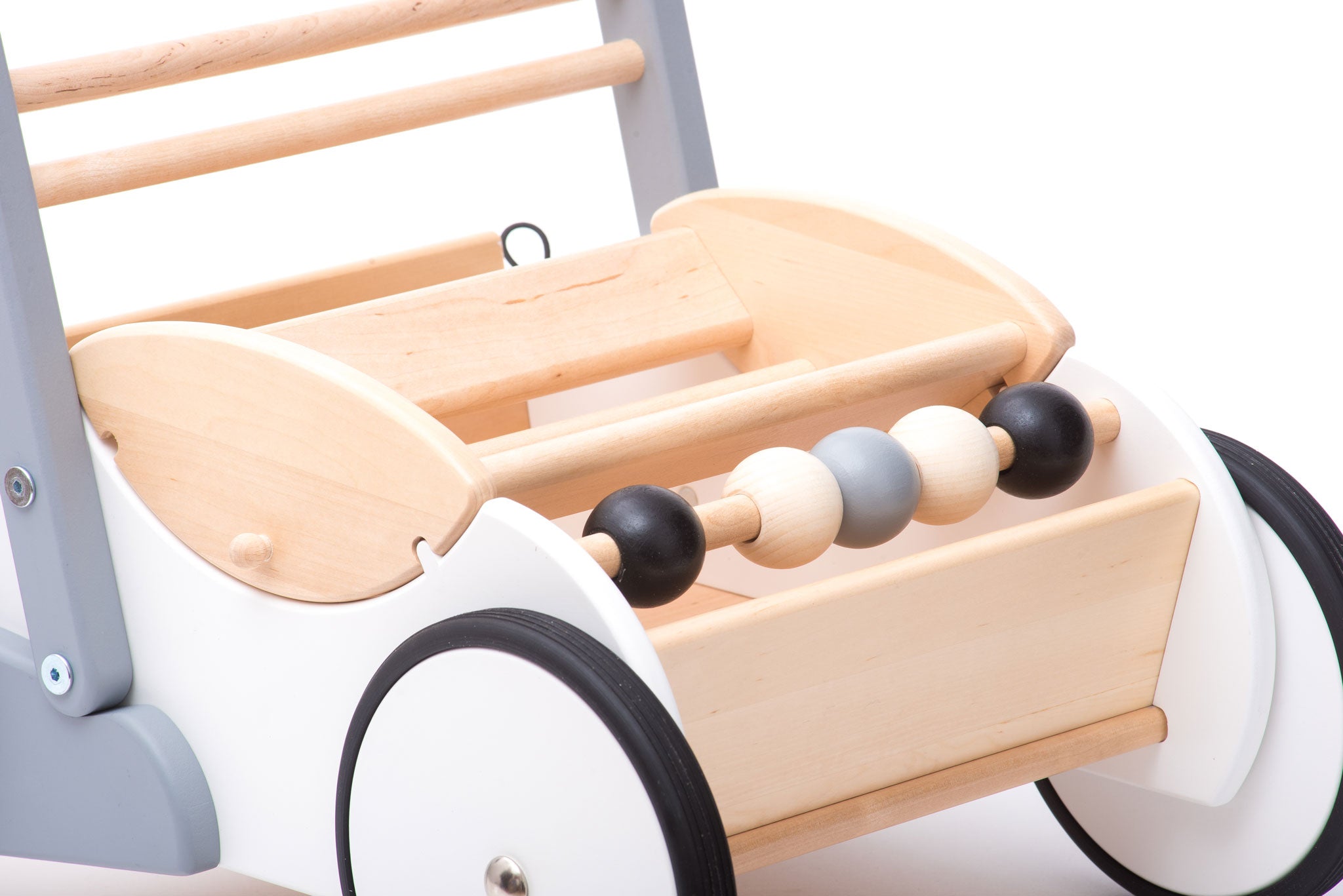 A close up of the wooden balls on the front of the Bajo Monochrome Baby Walker. A wooden push along baby walker with natural wood, white, grey and black details. These heirloom quality toys by Bajo are part of a wide range of wooden toys available here at Babipur. 