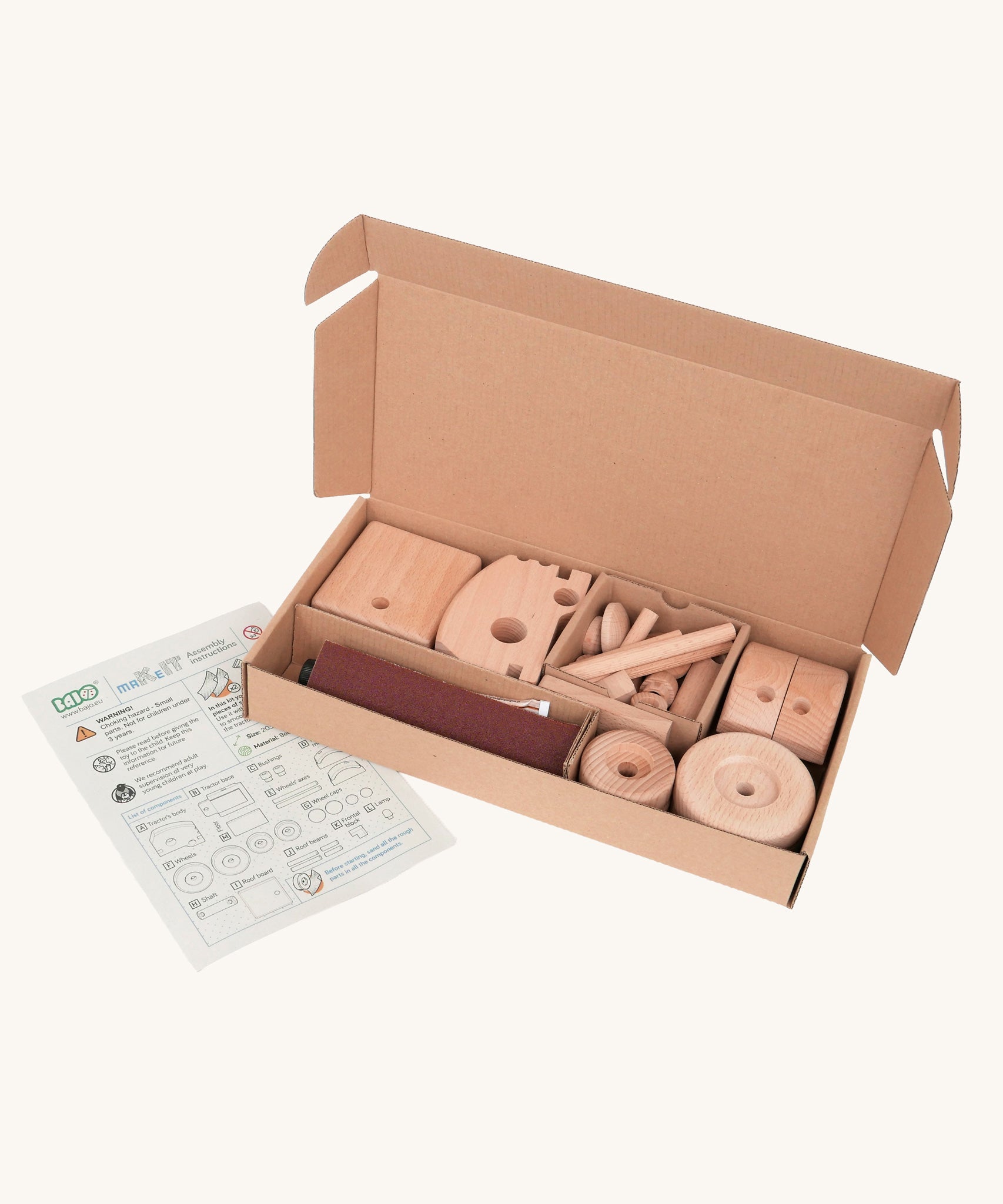 The pieces included in the Bajo DIY Tractor build your own kit in their box. These heirloom quality toys by Bajo are part of a wide range of wooden toys available here at Babipur. 