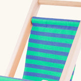 Close up of the blue and white stripe cotton on the Bajo wooden doll stroller toy.