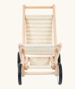Front on view of the Bajo wooden doll stroller toy with a cream and natural stripe cotton seat and shelf, white wooden wheels with black rubber trims. 