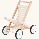 Bajo wooden doll stroller toy with a cream and natural stripe cotton seat and shelf, white wooden wheels with black rubber trims. 