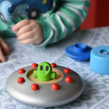Child playing with the Bajo Alien Flying Saucer, with the top two pieces taken off. 