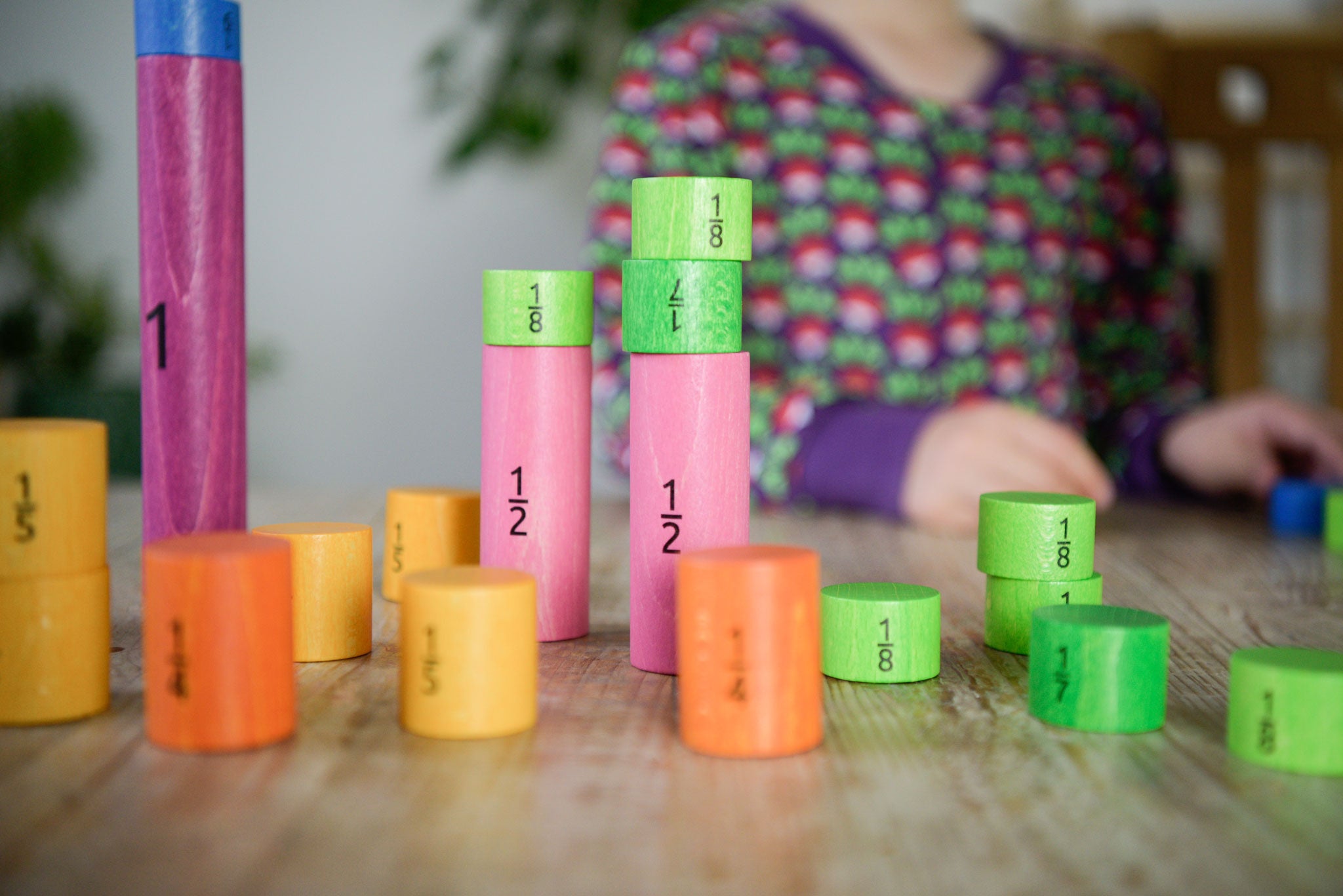 Bajo Fractions Set. A set of coloured wooden blocks marked with fractions on each block. These heirloom quality toys by Bajo are part of a wide range of wooden toys available here at Babipur.
