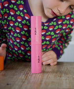 A child looking at the the two half fraction blocks from the Bajo Fractions Set. A set of coloured wooden blocks marked with fractions on each block. These heirloom quality toys by Bajo are part of a wide range of wooden toys available here at Babipur.
