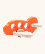 Bajo Toys wooden push along airplane in orange with 3 cut out holes as window, unpainted wings and wheels
