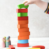 A person stacking the Bajo Rainbow Blocks on top of each other making a horizontal stack