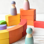 Grimm's figures stood on an around the Bajo Rainbow blocks