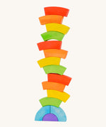 Bajo handmade wooden rainbow block toys stacked in a tower on a white background