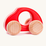 Bajo handmade wooden beetle style car in red and available at Babipur features unpainted wheels, can be pushed or pulled along.