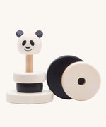 A Bajo Panda Stacker wooden toy  with two of the circle stacking pieces taken off. This black and white stacking toy has four removable rings and a panda head that fit onto a wooden pole and base. These heirloom quality toys by Bajo are part of a wide range of wooden toys available here at Babipur. 