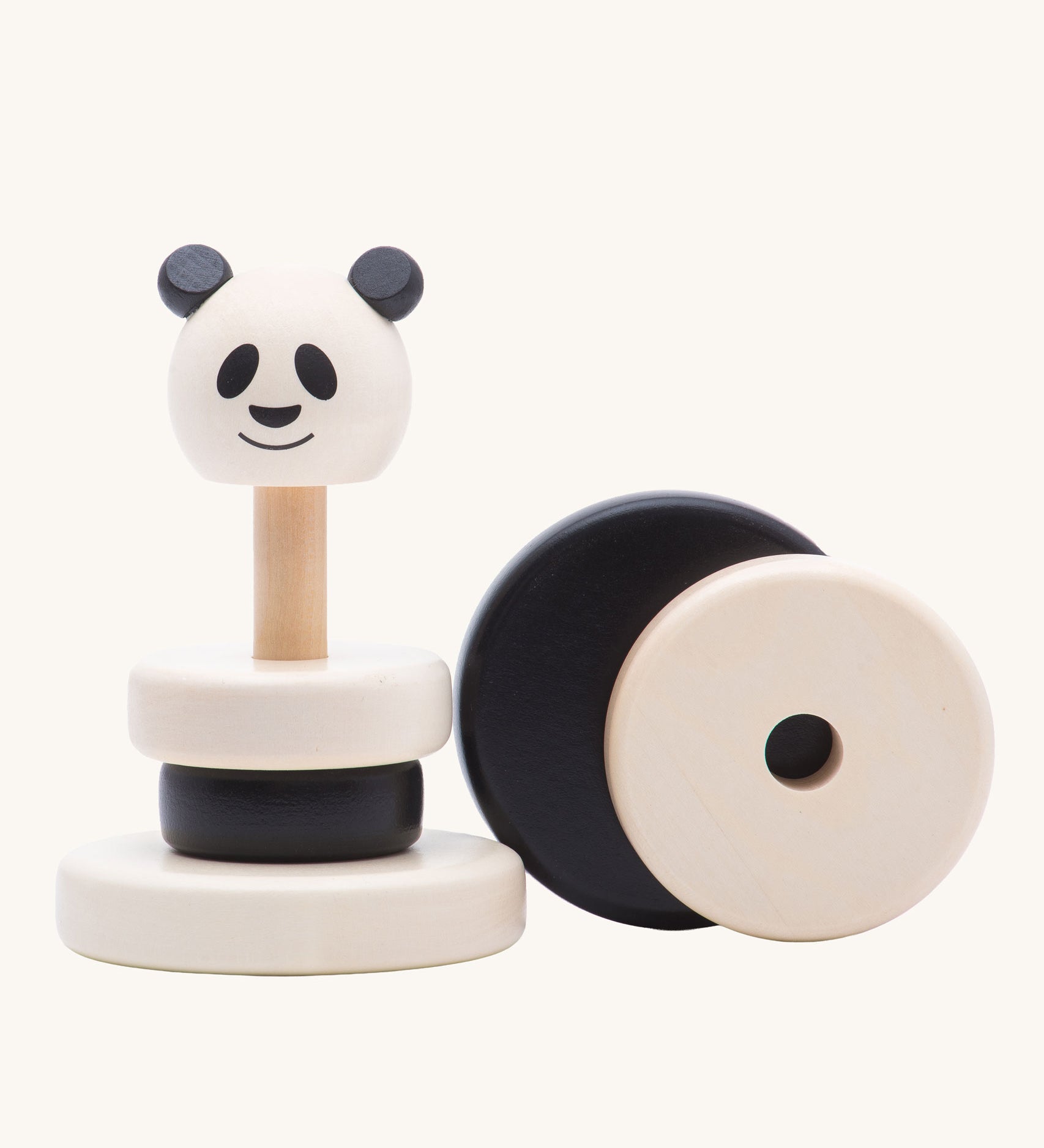 A Bajo Panda Stacker wooden toy  with two of the circle stacking pieces taken off. This black and white stacking toy has four removable rings and a panda head that fit onto a wooden pole and base. These heirloom quality toys by Bajo are part of a wide range of wooden toys available here at Babipur. 