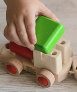 Child putting the green removable roof piece on the Bajo train
