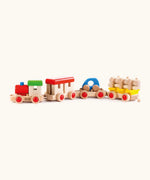 Bajo wooden train to build set. Features a DIY train and 3 carriages with removable pieces, a car and log stack