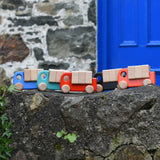 A collection of Bajo trucks with blocks placed on a stone wall 