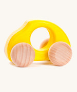 Bajo handmade wooden beetle style car in yellow and available at Babipur features unpainted wheels, can be pushed or pulled along.