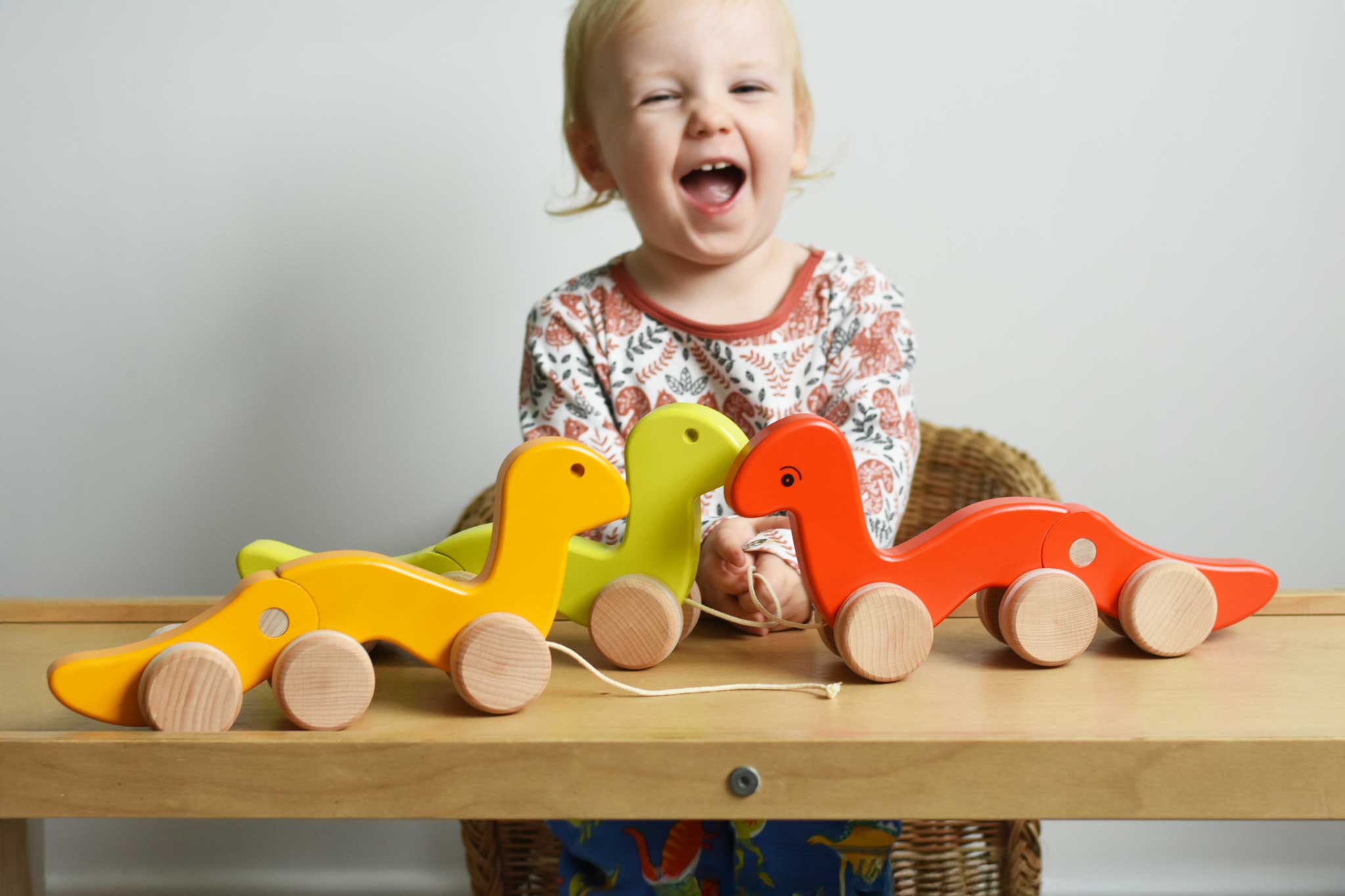 Three Bajo wriggling toy worms placed on a Triclimb Miri slide in front of a child. These heirloom quality toys by Bajo are part of a wide range of wooden toys available here at Babipur. 