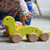 A child reaching for a green Bajo wriggling worm pull along toy. These heirloom quality toys by Bajo are part of a wide range of wooden toys available here at Babipur. 
