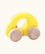 Bajo handmade wooden ellipse car in yellow with a  oval cut out in the center for grip and unpainted wheels