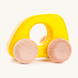 Bajo hand made wooden yellow mini style car available at Babipur. Features unpainted wheels and a cut out hole for easy grabbing